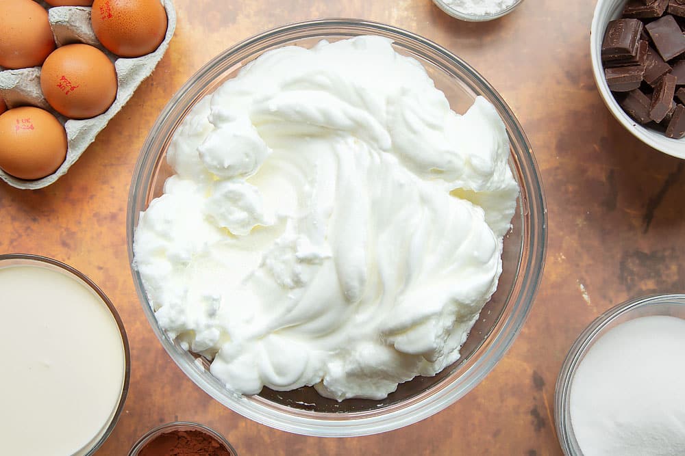 Egg whites in a mixing bowl, beaten until stiff.