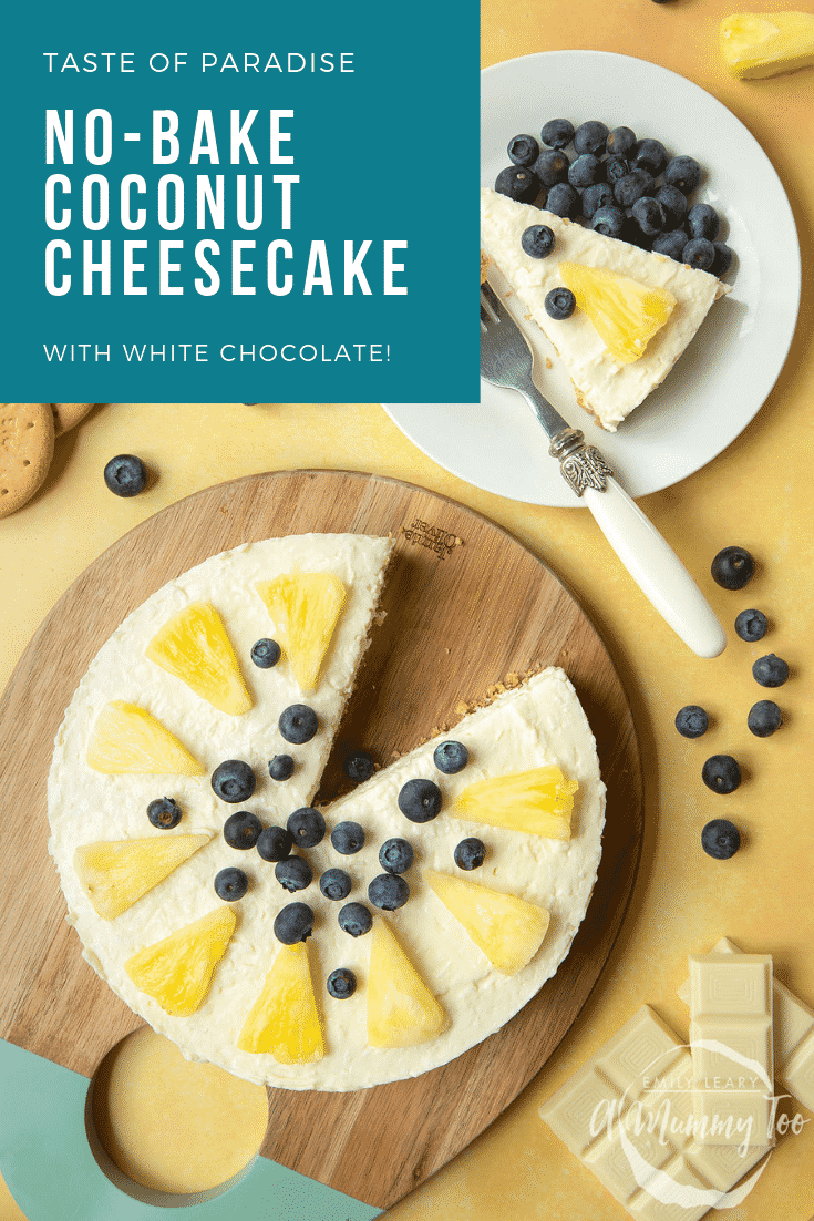 Coconut cheesecake decorated with fruit and arranged on a serving board, with another slice on a plate 