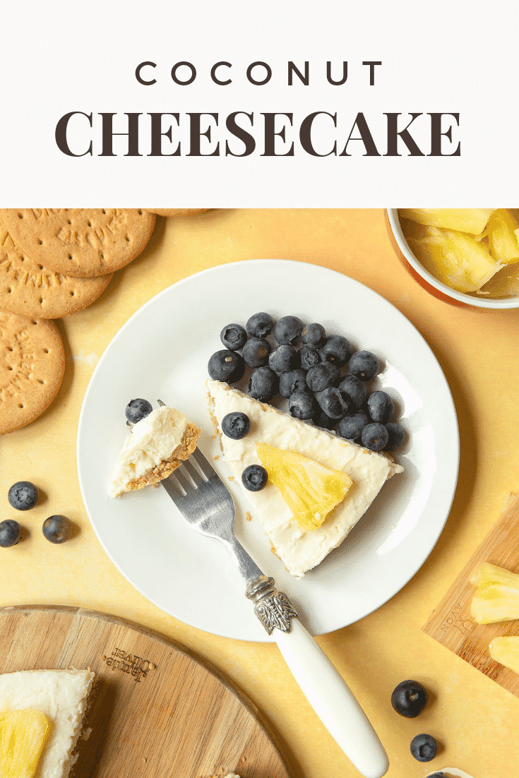 A slice of coconut cheesecake decorated with fruit and served on a plate