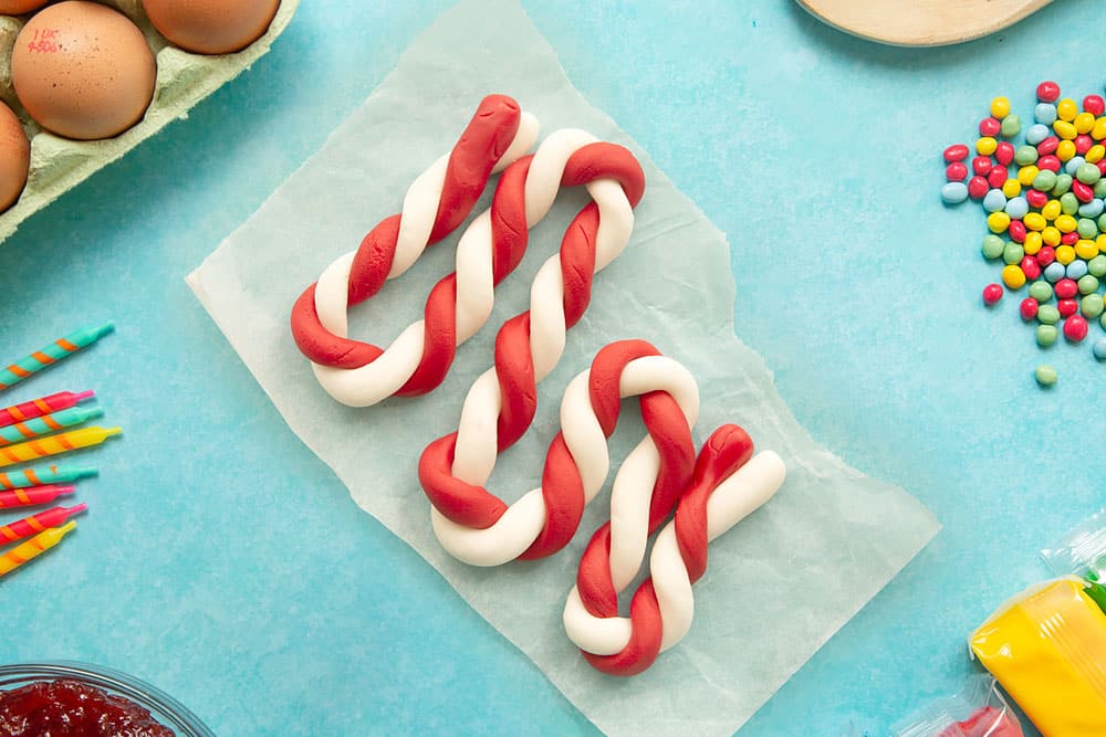 Red and white lengths of sugar paste, twisted together