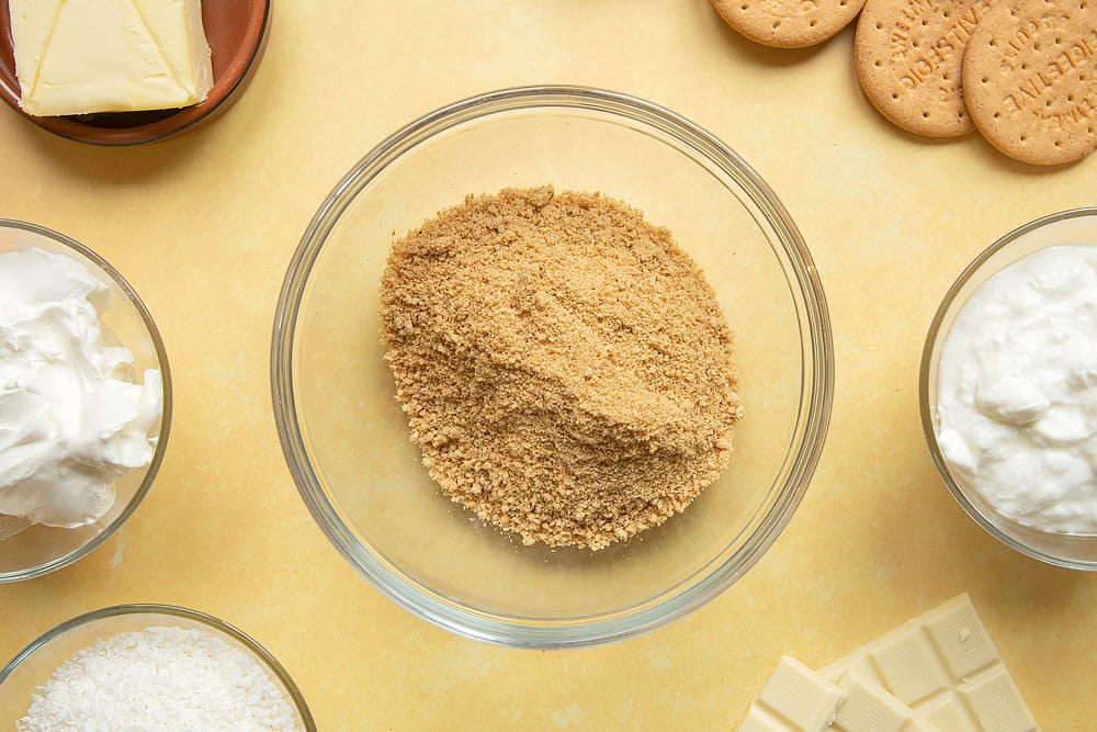 Crushed digestive biscuits in a mixing bowl.