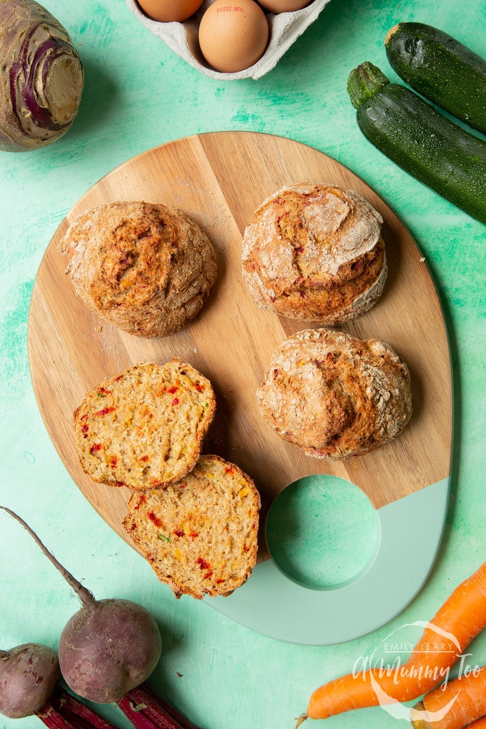 Vegetable soda bread rolls recipe - rolls arranged on a board, one cut open to show the vegetable flecked interior.