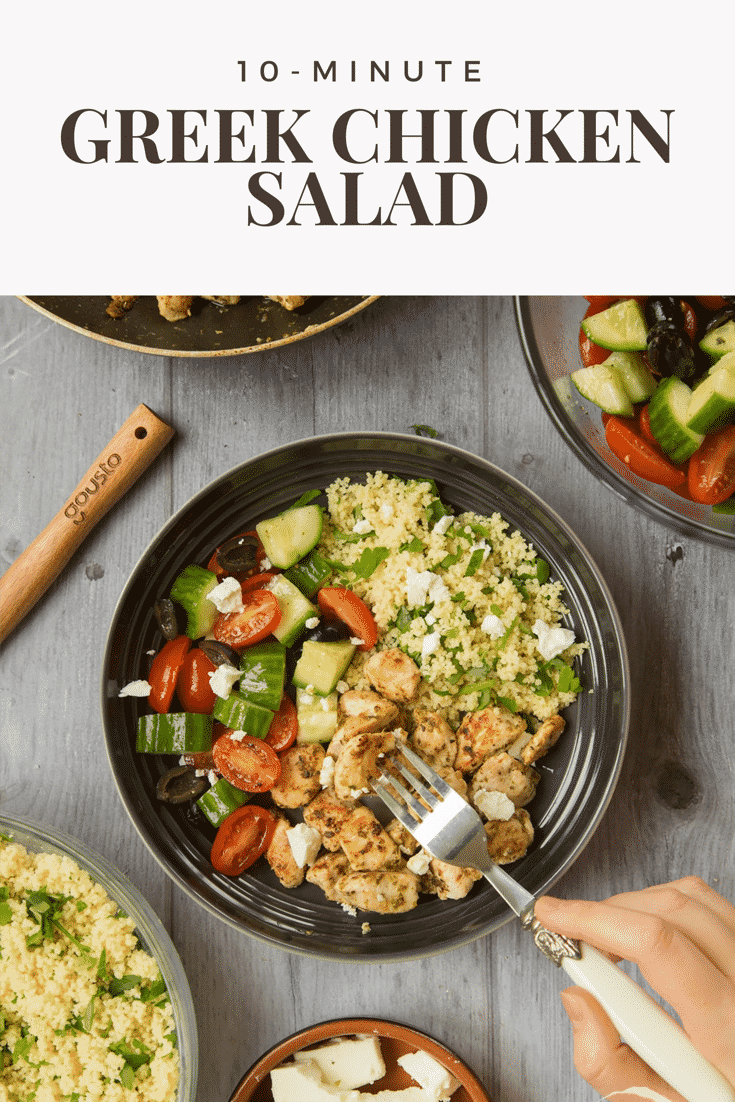 Overhead shot of a decoative fork going into a black bowl with chicken salad. At the top of the image there is some brown text describing the image for Pinterest. 