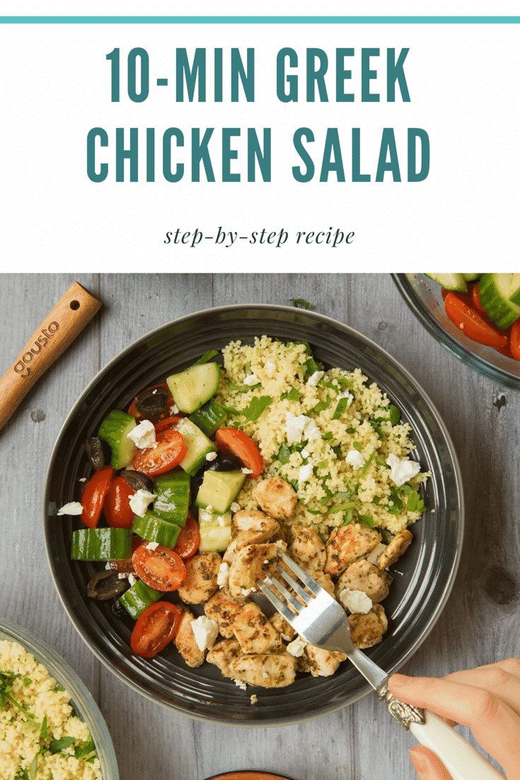Overheat shot of a black bowl filled with chicken salad ontop of a wooden table. A decoative fork is going into the bowl and pulling out a piece of chicken. At the top of the image there is some text describing the image for Pinterest.