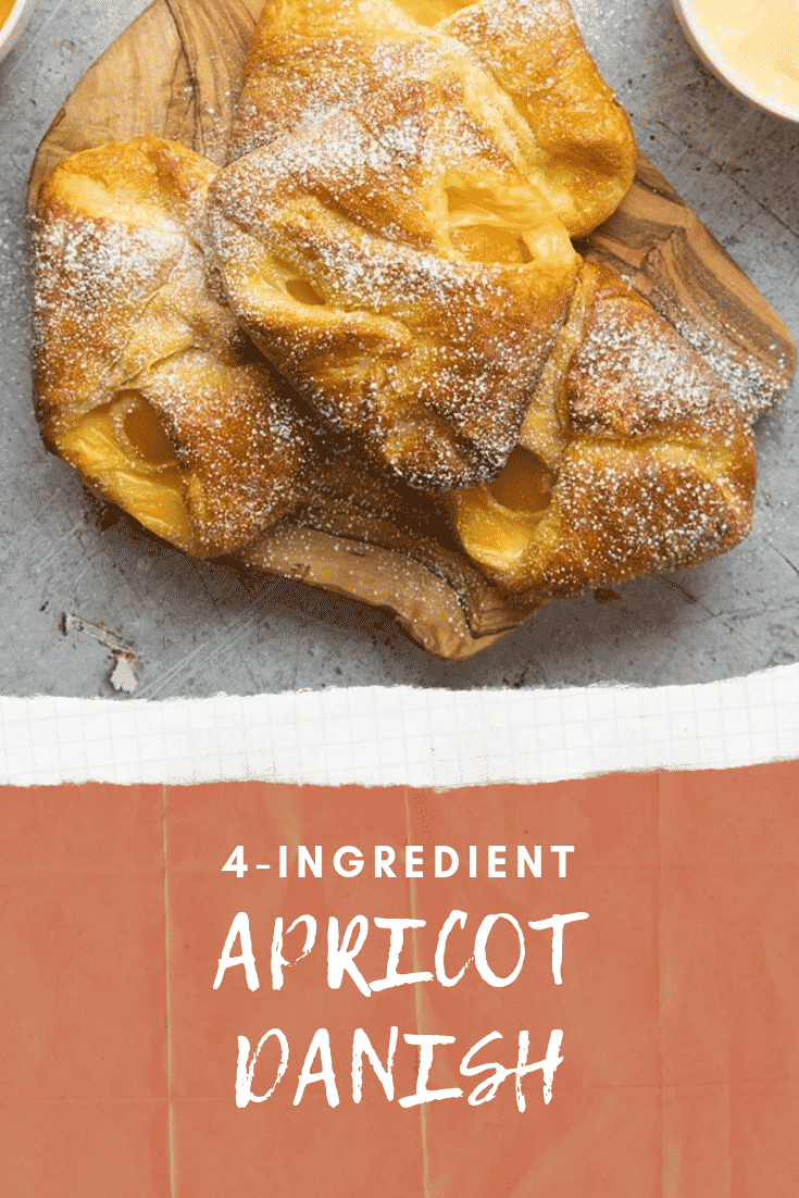 Close up overhead shot of a finished apricot danish on a grey table. At the bottom of the image there's some white text on a red background describing the image for Pinterest.