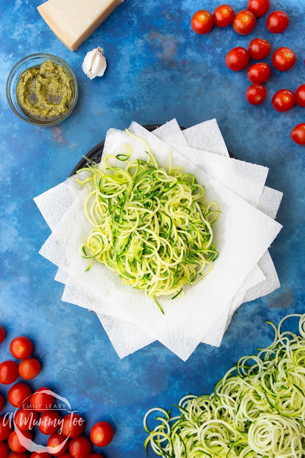 Cooked spiralised courgette on a plate lined with kitchen towel