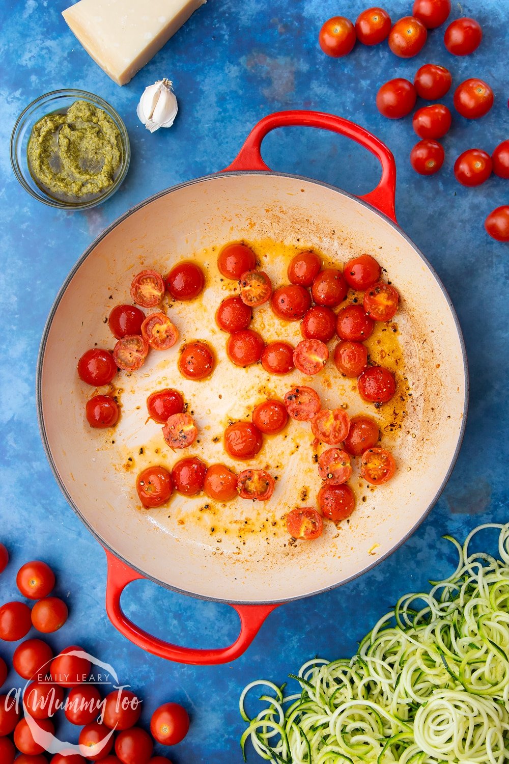 Cherry tomatoes, garlic, olive oil, black pepper and spiralised courgette in a frying pan - the tomatoes have been briefly cooked