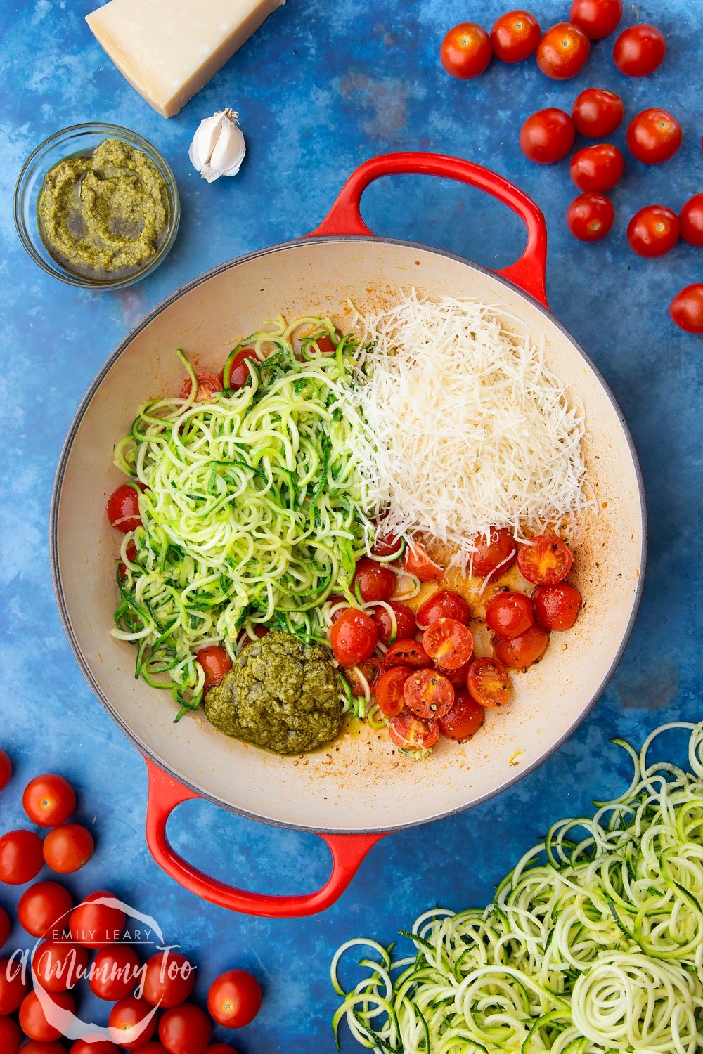 Cherry tomatoes, pesto, grated parmesan, garlic, olive oil, black pepper and spiralised courgette in a frying pan