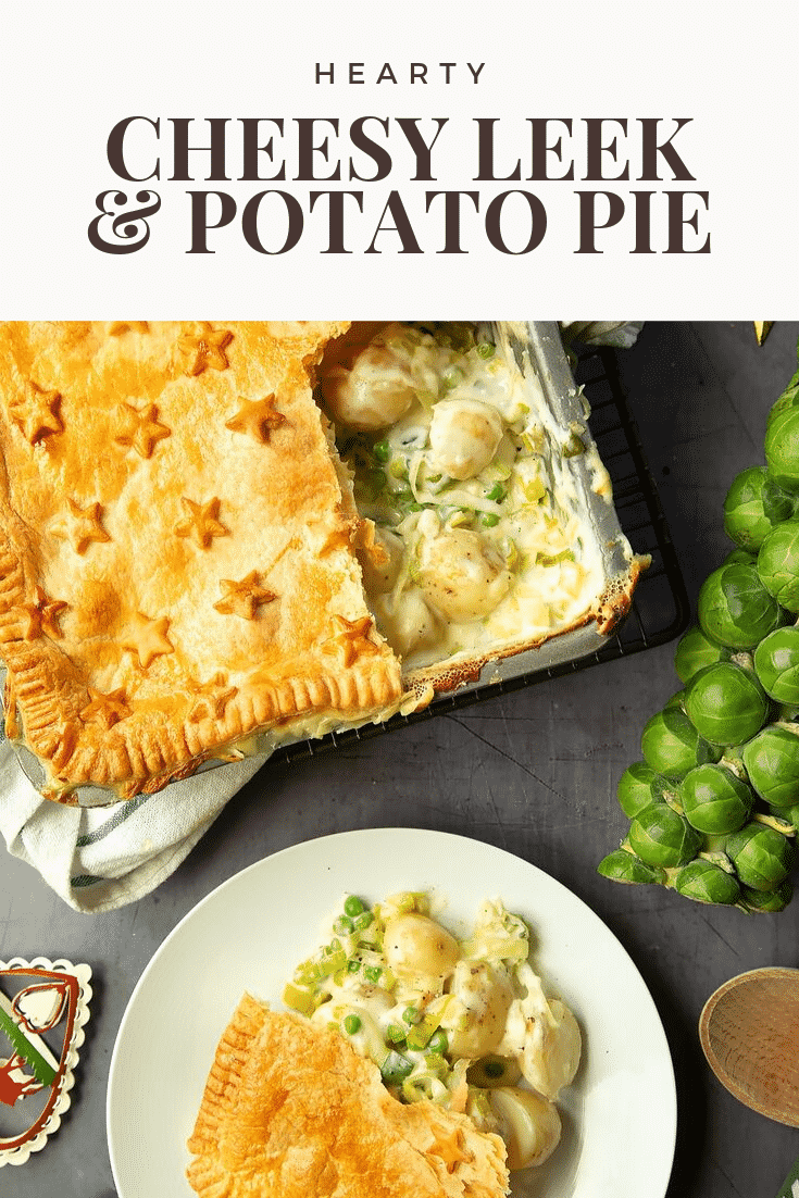 Overhead shot of the leek and potato pie. A slice has been cut from the tray and placed on a white plate. At the top of the image there is some text describing the image for Pinterest. 