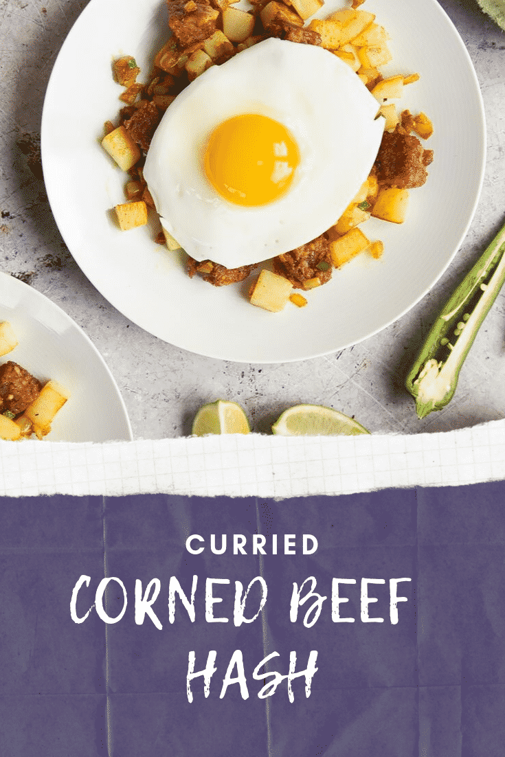 Close up overhead shot of the finished curried corned beef hash. At the bottom of the image there's some white text on a blue background describing the image for Pinterest.