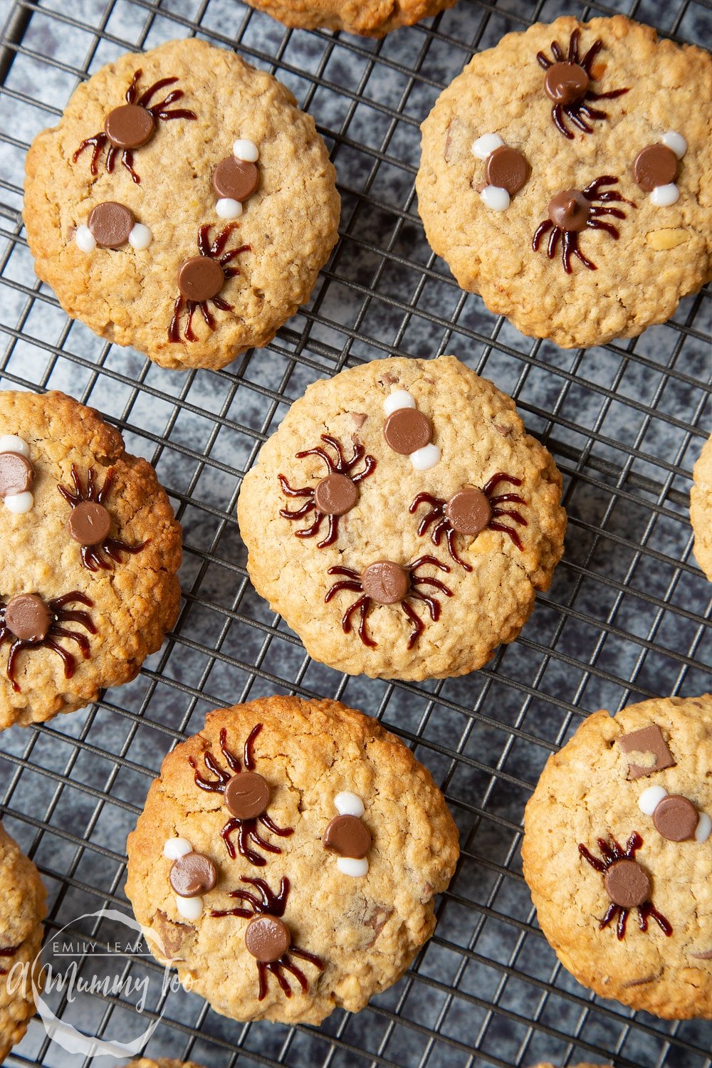 Full decorated Halloween peanut butter spider cookies on a wire rack. 