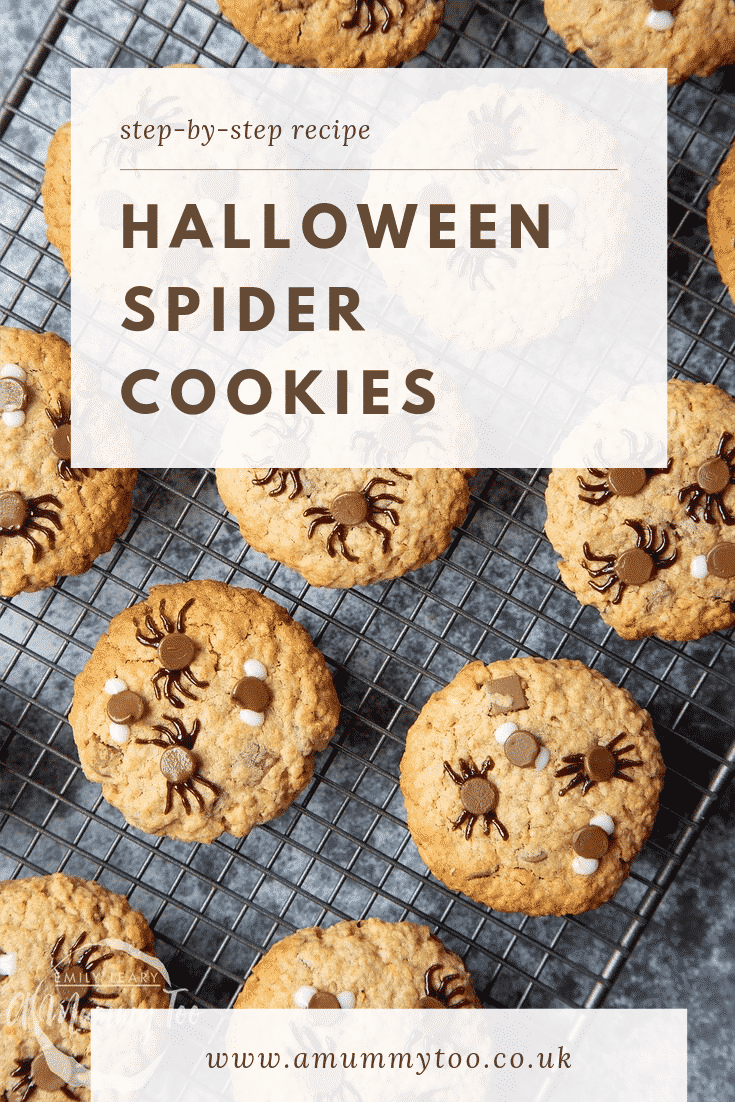 Halloween peanut butter spider cookies resting on a cooling tray having just come out the oven.