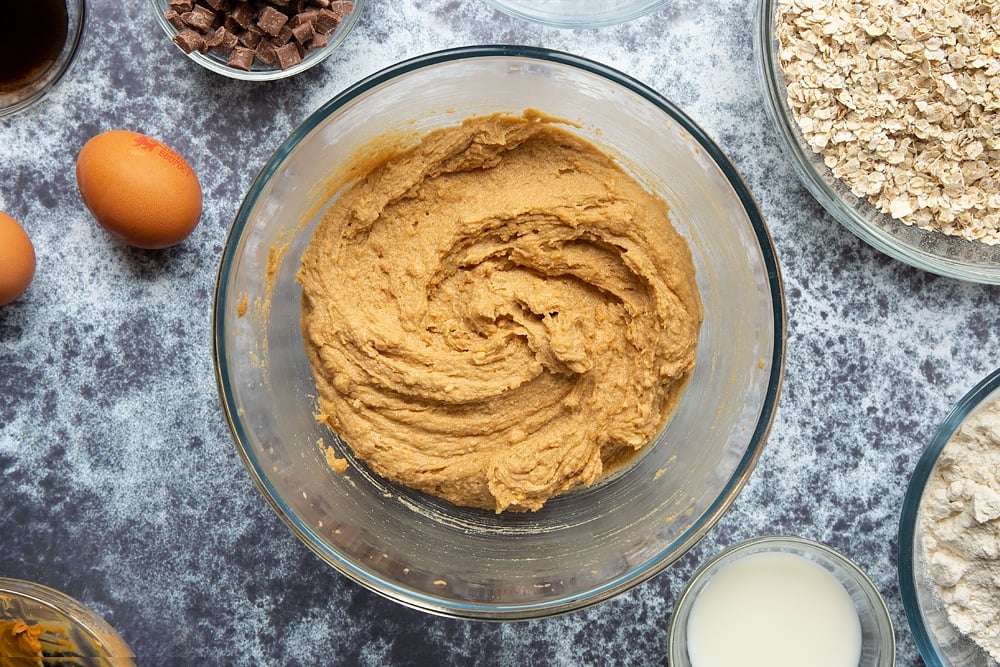 Sugar, butter and peanut butter whisked together in a bowl.