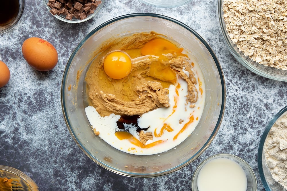 Sugar, butter and peanut butter whisked together in a bowl. Eggs, milk and vanilla added.