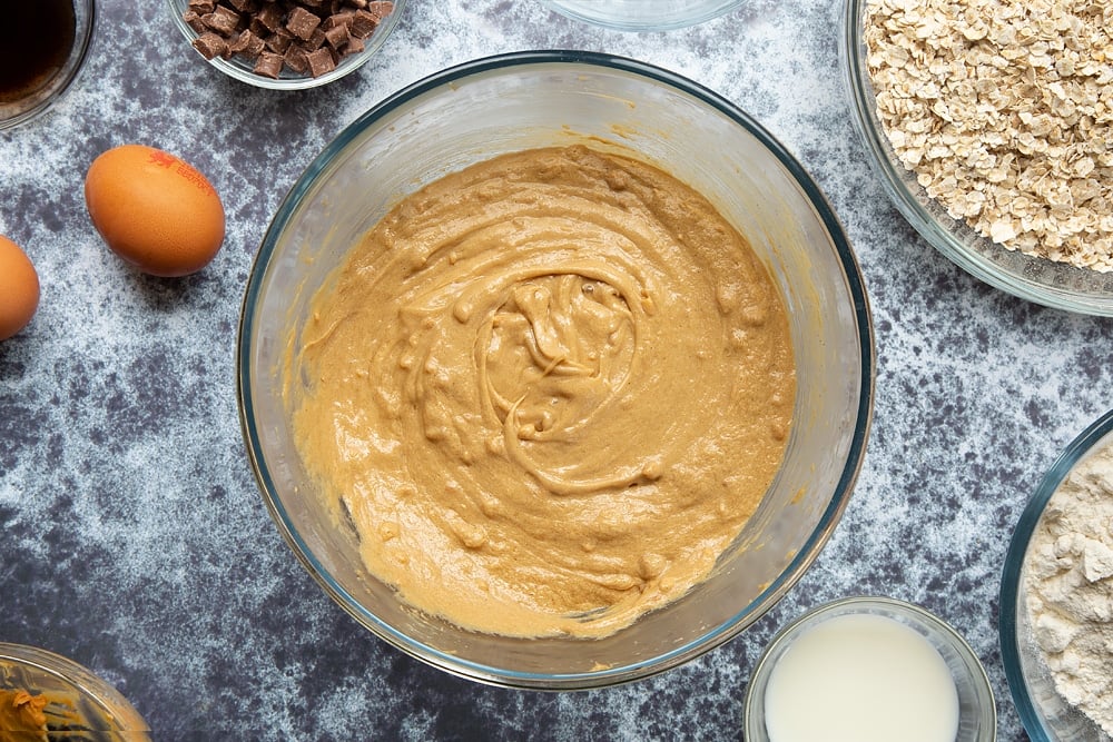 Sugar, butter, peanut, eggs, milk and vanilla whisked together in a mixing bowl.