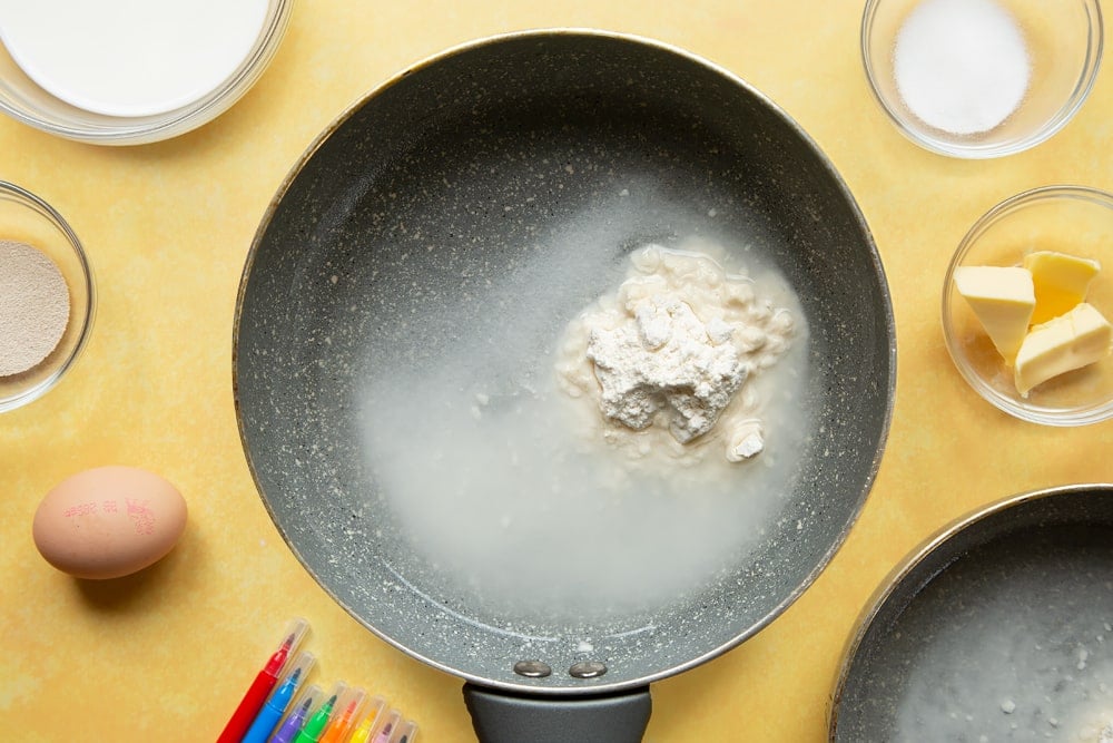 Strong white bread flour and water in a small pan.