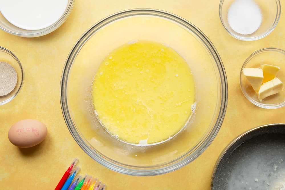 Warm milk and warm butter in a large bowl.