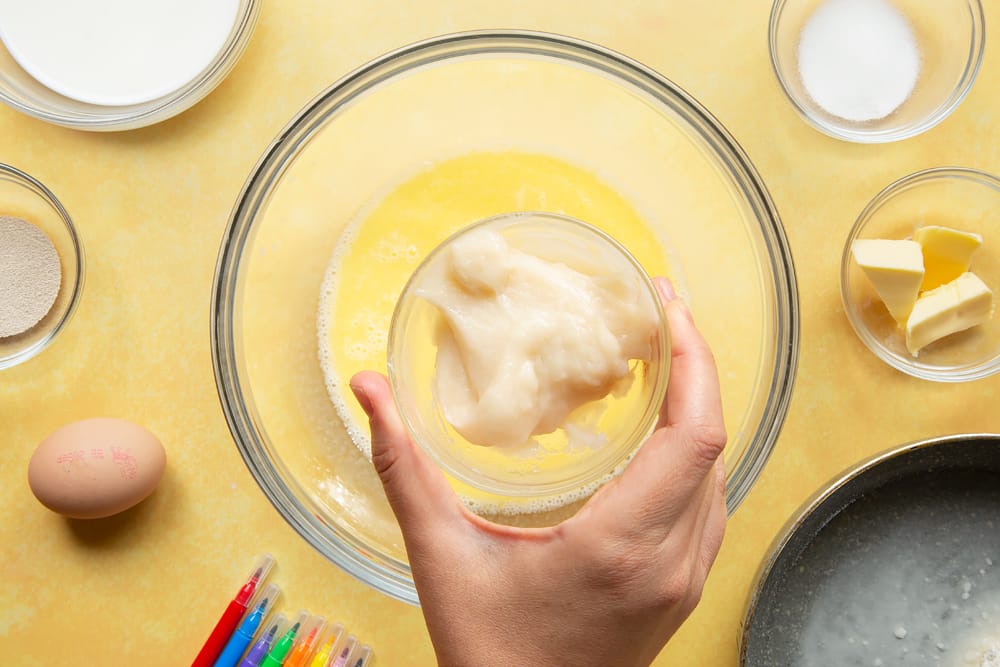 Adding tangzhong to a mix of sugar, warm milk and warm butter in a large bowl.