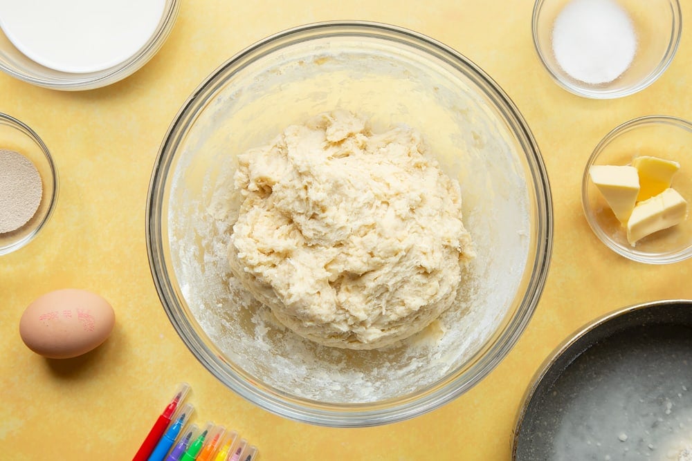 Flour, yeast, egg, tangzhong, sugar, warm milk and warm butter mixed together in a large bowl to form a shaggy tangzhong bread dough.