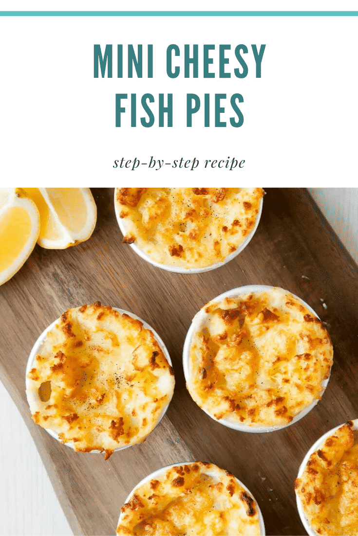 Overhead shot of five mini fish pies on a wooden board with a side of chopped lemon. At the top of the image there's some teal text describing the image for Pinterest. 