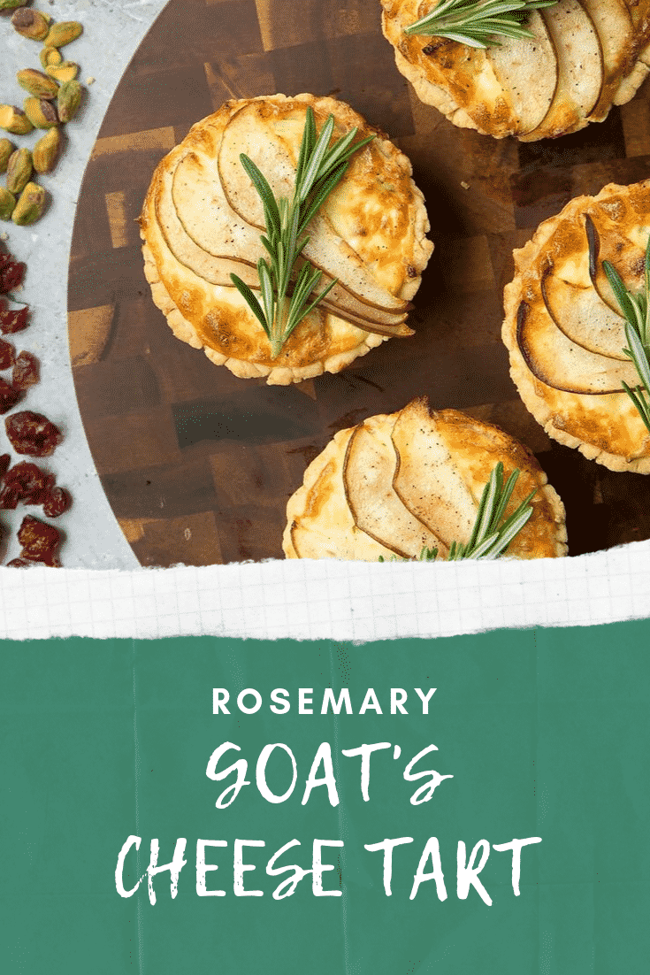 Overhead shot of three rosemary goats cheese darts on a dark wooden circular board with some nuts and rasins at the side. At the bottom of the image there's some white text on a teal background describing the image for Pinterest.