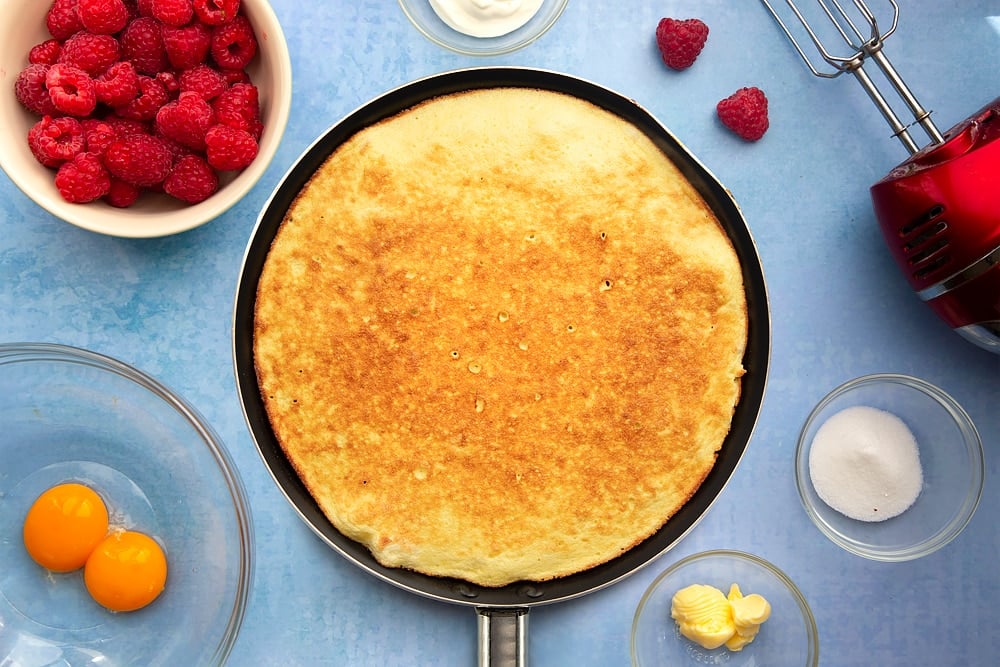 Large nonstick pan containing a cooked sweet omelette