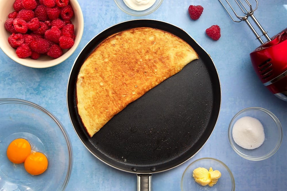 Large nonstick pan containing a cooked sweet omelette, folded in half