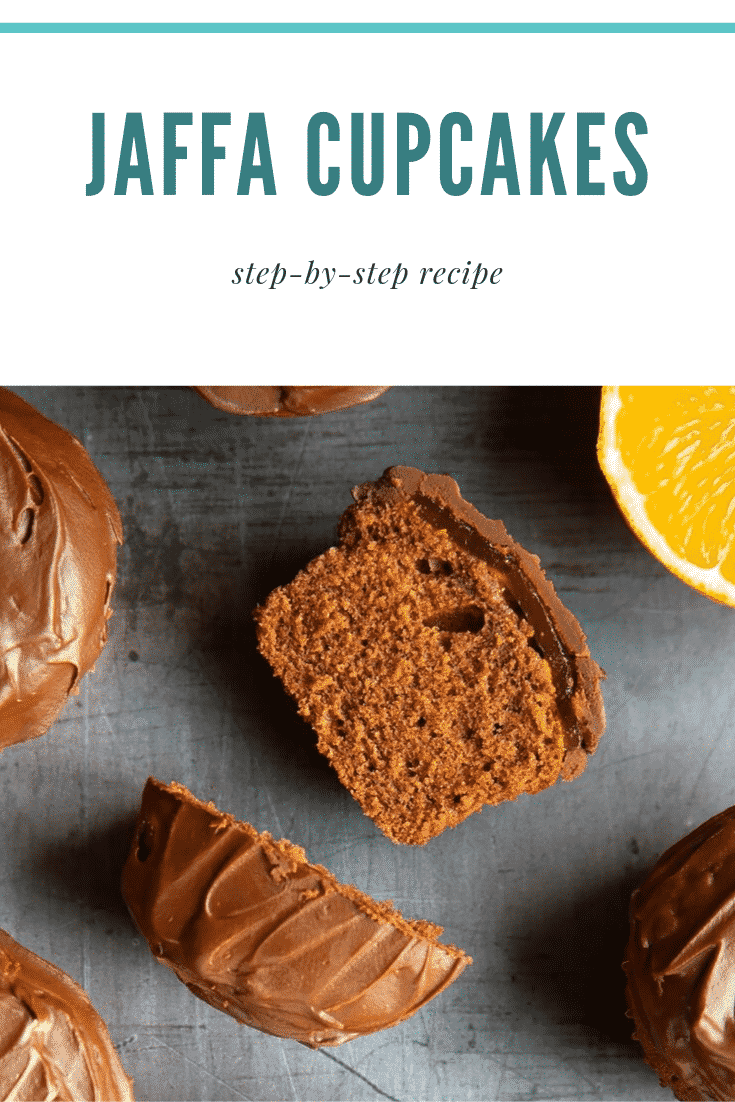 Overhead shot of the jaffa cupcakes sat on a grey background. The cupcake has been cut open and one side is stood upright and the other on its side. At the top of the image there's some text describing the image for Pinterest. 