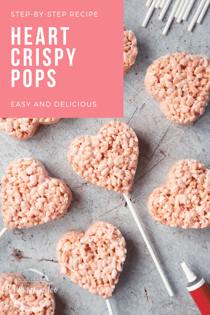 Close up of heart crispy cake pops on a grey background. At the top right of the image there's some text on a pink background explaining the image for Pinterest purposes. 