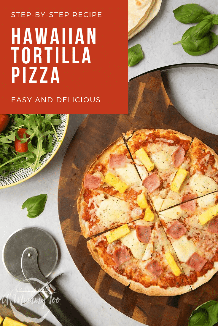 Overhead shot of a finished hawaiian tortilla pizza on a wooden board with a salad in a bowl on the side. At the top left hand side of the image there's some white text on a red background describing the image for Pinterest. 