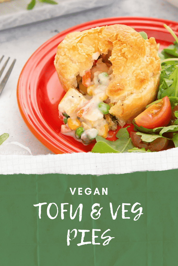Close up side on view of the cut open vegan pie on a red plate with some salad on the side. At the bottom of the image there's some white text on a green background describing the image for Pinterest.