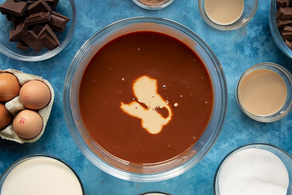 Adding baileys to the baileys triple chocolate trifle ganache ingredients.