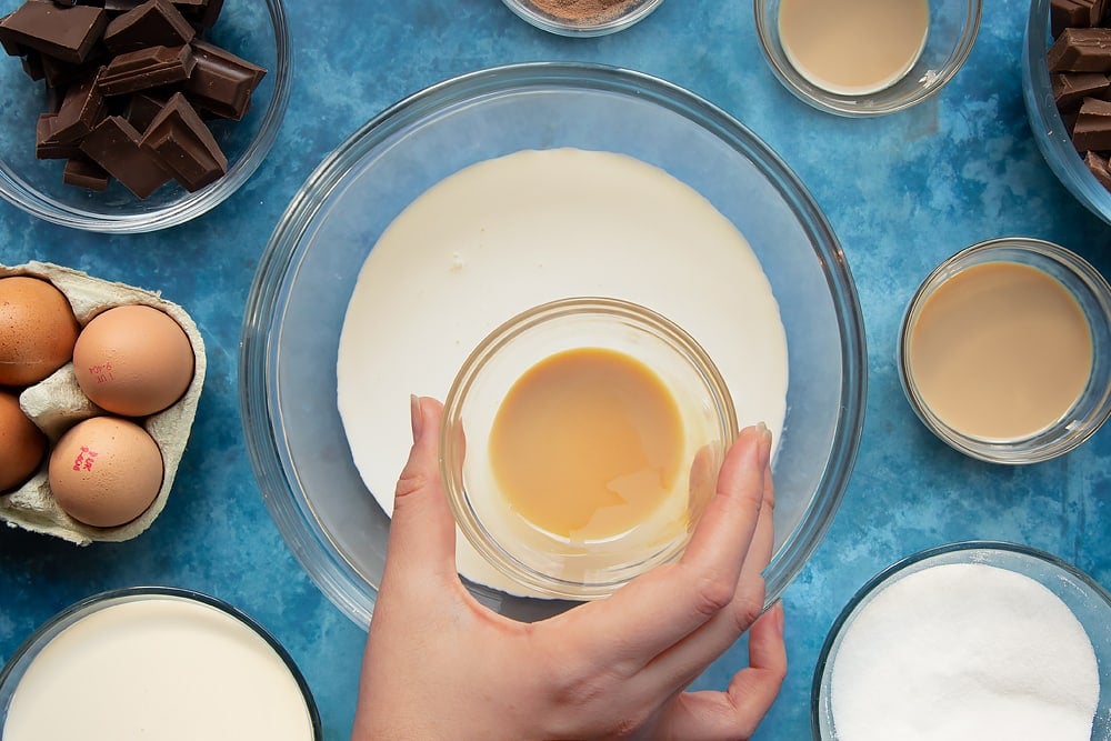 Baileys being added to the baileys cream topping ingredients ready for the baileys triple chocolate trifle