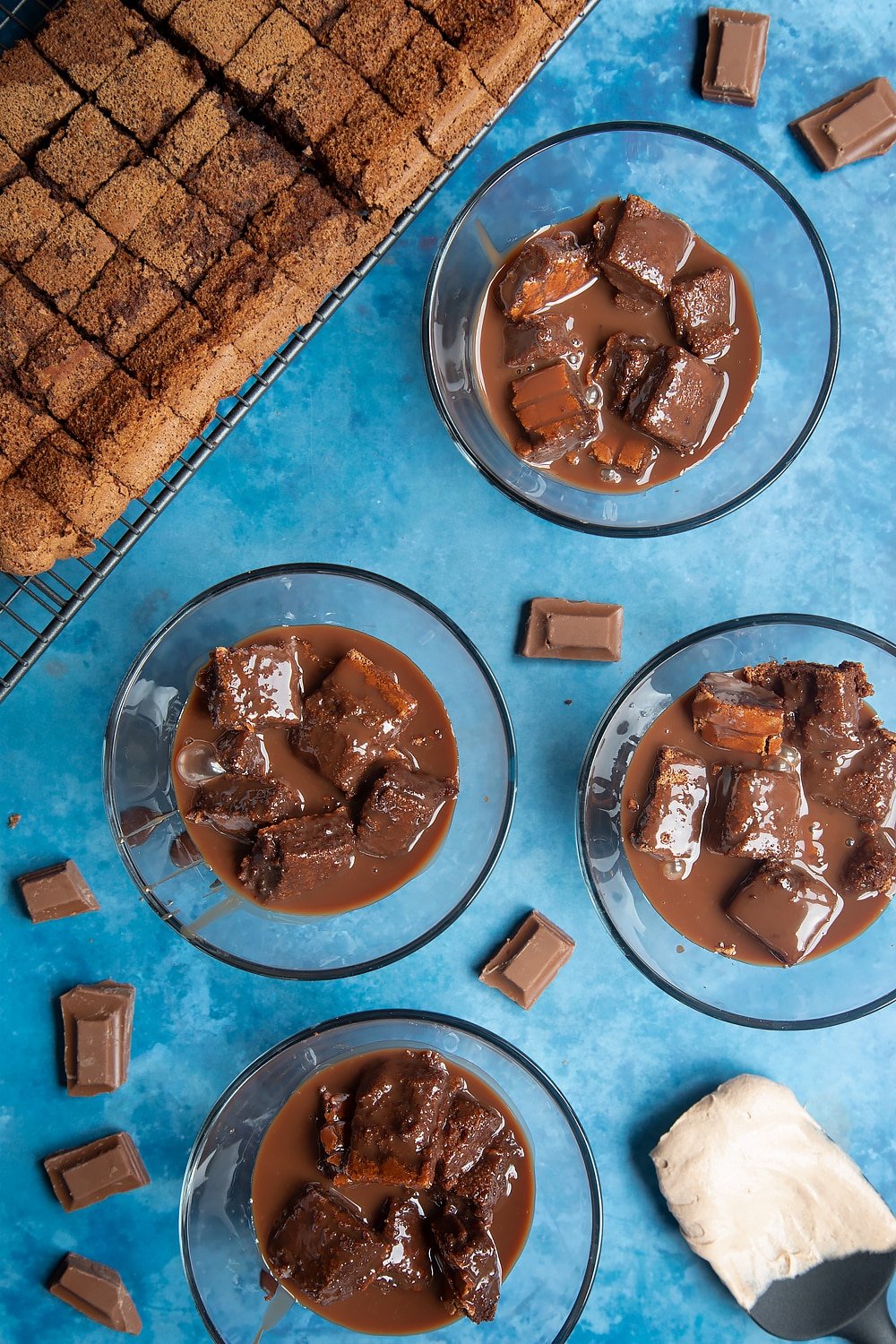 The baileys triple chocolate trifle sponge in a desert bowl after adding the cooled ganache