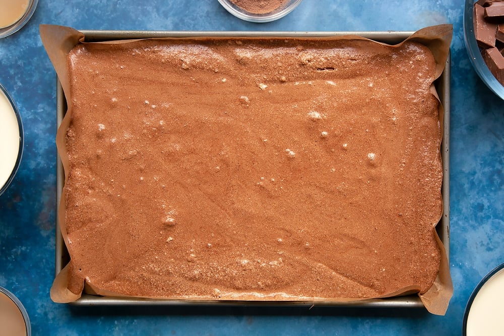 baileys triple chocolate trifle mixture poured into a baking tin.