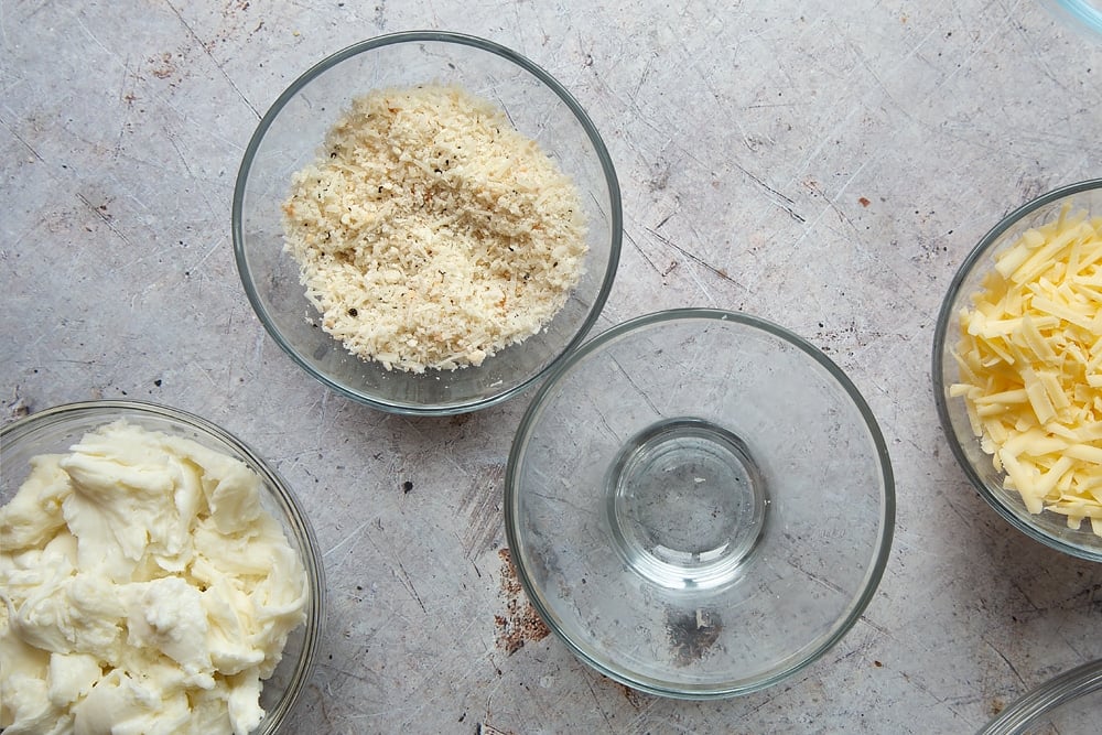 Overhead shot of some bowls of cheese being mixed together. 