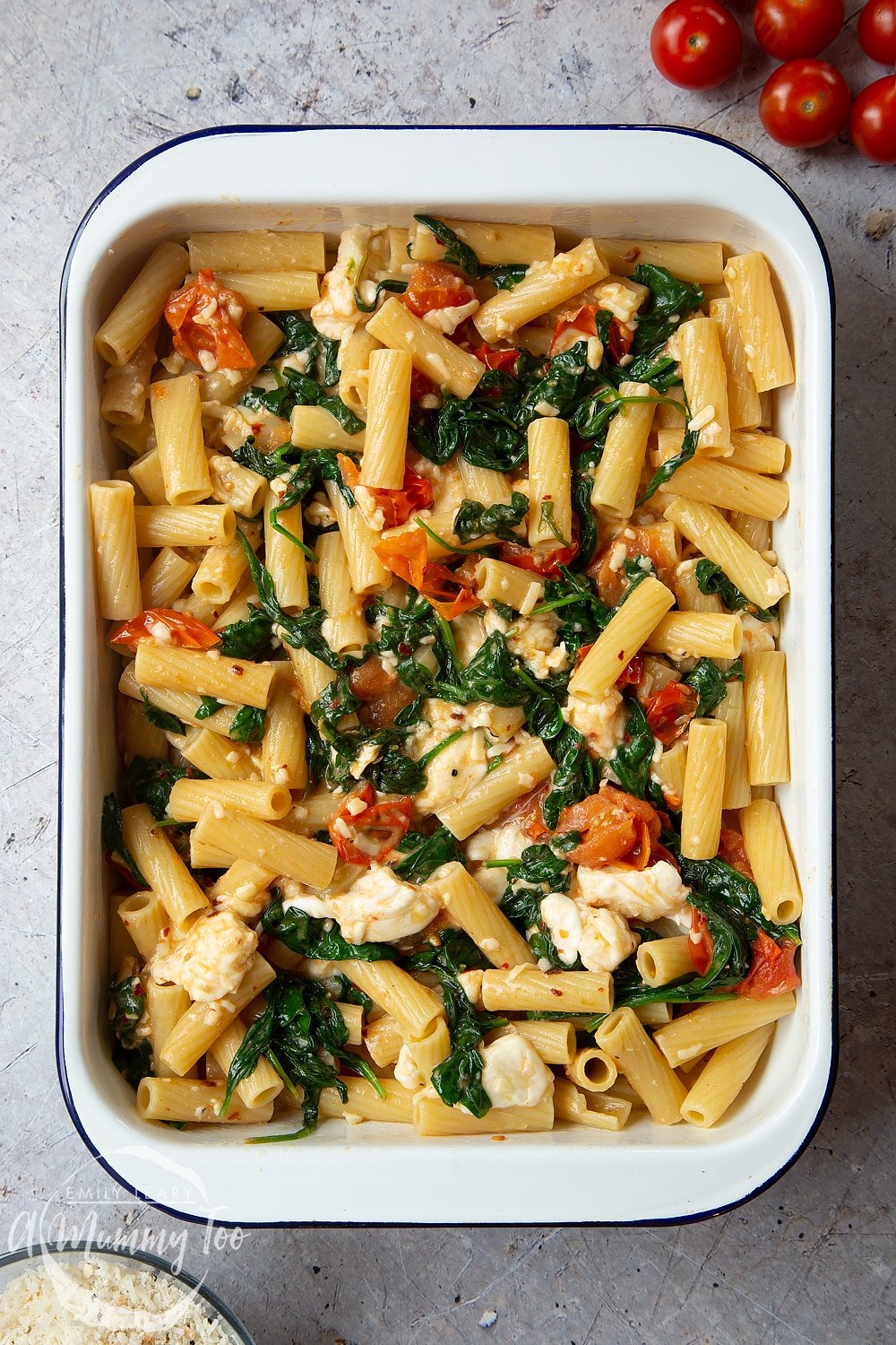 Cherry tomato, spinach and garlic mozzarella pasta bake in a roasting tin. 