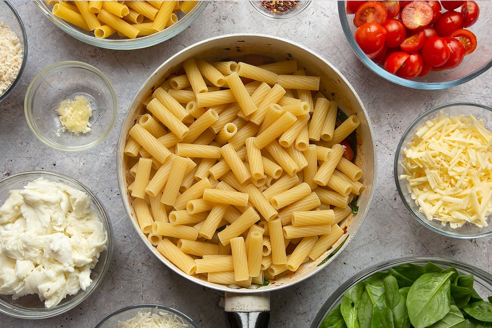 Overhead shot of some semi cooked pasta in a pan.