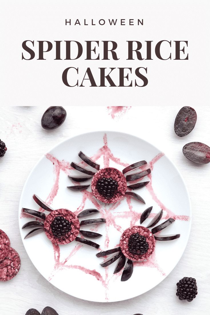 Halloween rice cakes, decorated with blackberries & grapes to look like spiders on a spider's web. Caption reads: Halloween spider rice cakes.