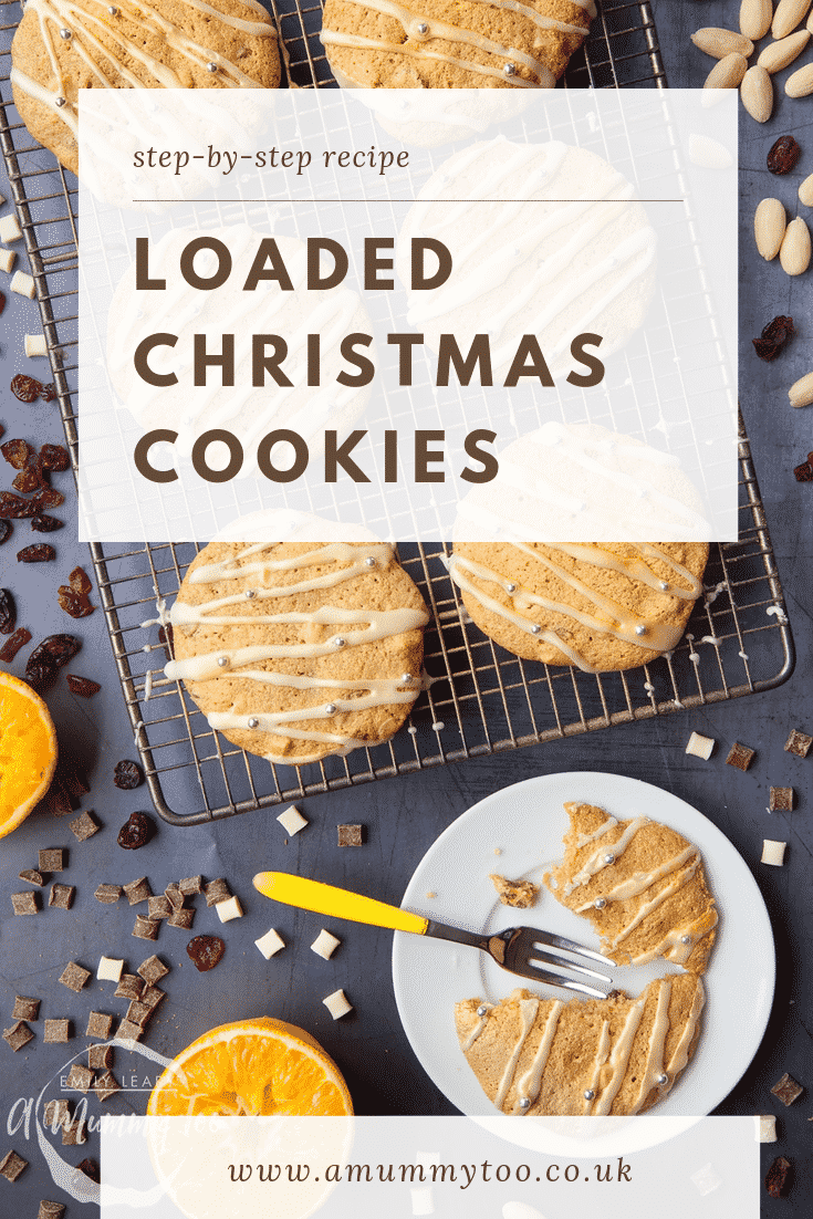 Overhead shot of loaded Christmas cookies on a cooling rack with one cookie on a white plate cut with a fork.