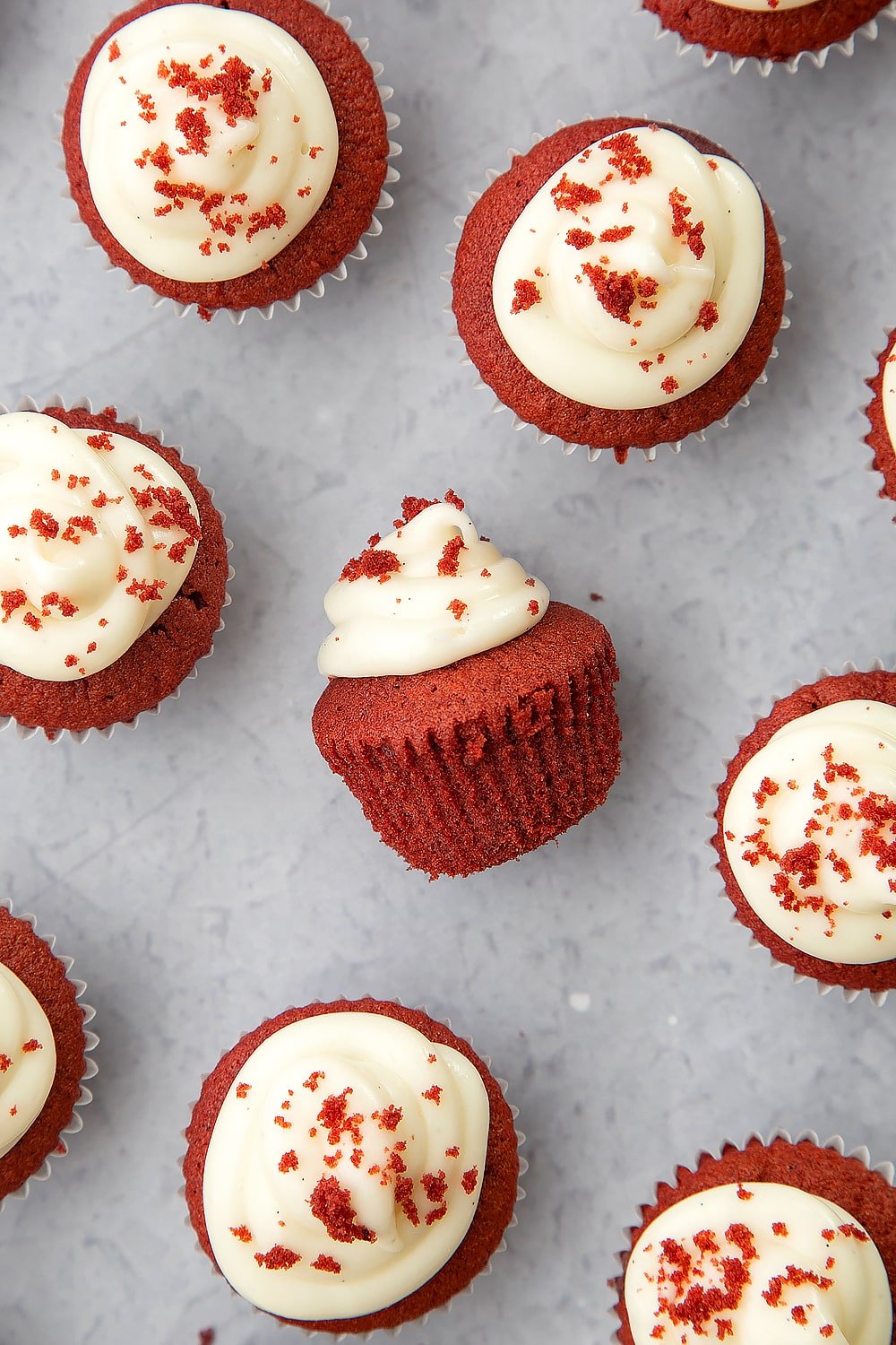 Overhead shot of mini red velvet cupcakes with cream cheese frosting.