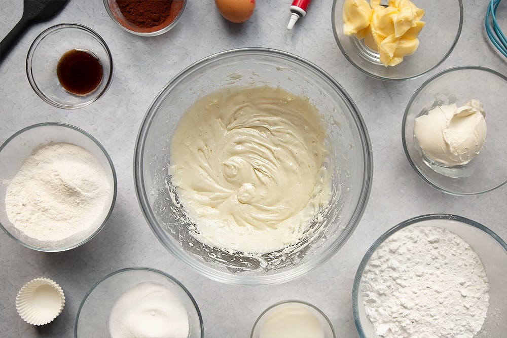 Cream cheese frosting having been mixed together in a bowl. 