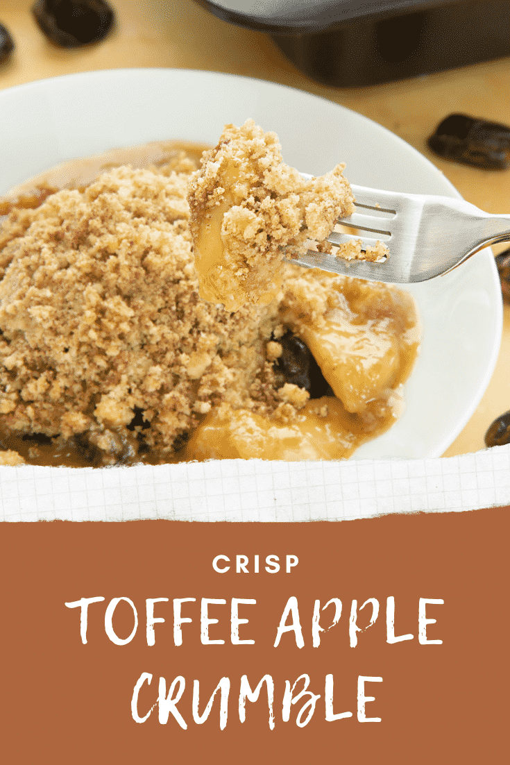 A fork taking out some of the toffee apple crumble from the plate. At the bottom of the image there's some text describing it for Pinterest. 
