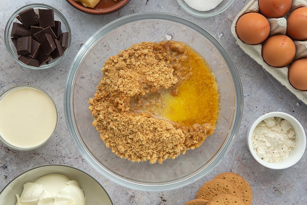 Overhead shot of the ingredients for the baked chocolate cheesecake being mixed together. 