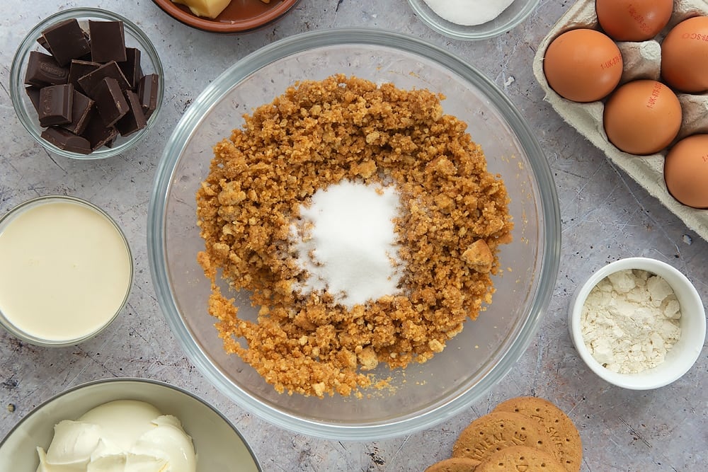 Overhead shot of some of the ingredients required to make the baked chocolate cheesecake mixed together. 