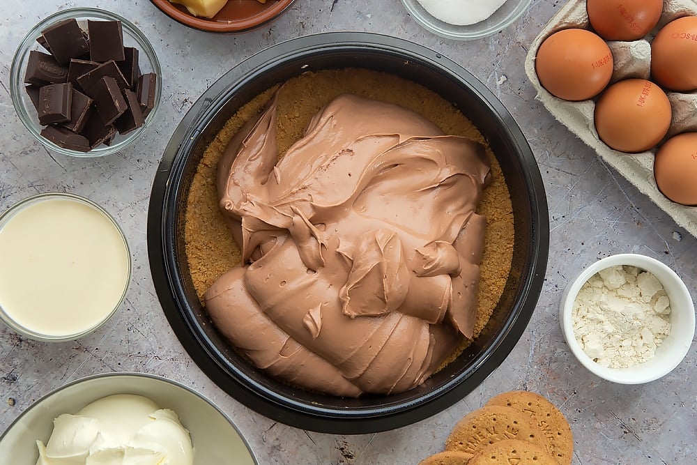 Overhead shot of the mixture being poured ontop of the biscuit base. 