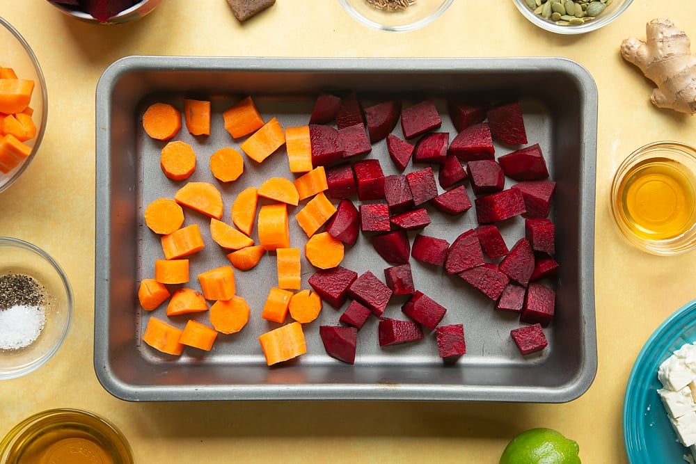 Overhead shot of the chopped beatroot and butternut squash in a pan. 