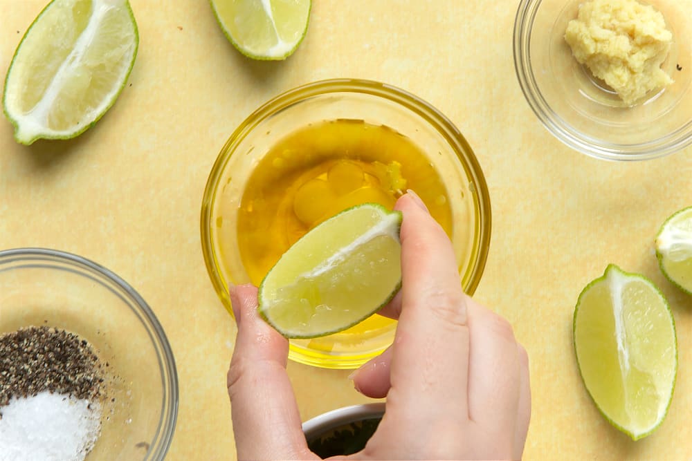 Squeezing a lime into a bowl to make the dressing for the Beetroot and feta salad with couscous.