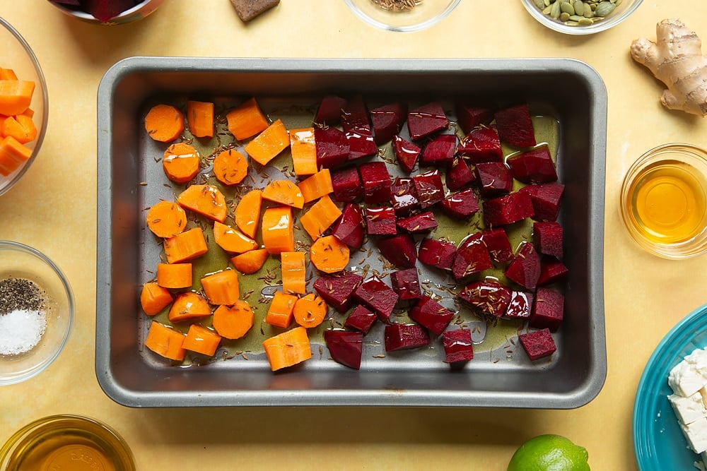 Adding seasoning to the pan of ingredients for the Beetroot and feta salad with couscous.