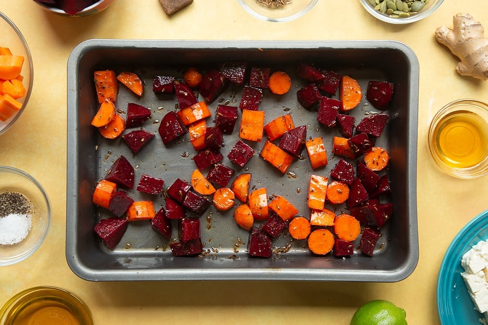 The pan on a yellow table after the ingredients required for the Beetroot and feta salad with couscous have been mixed together. 